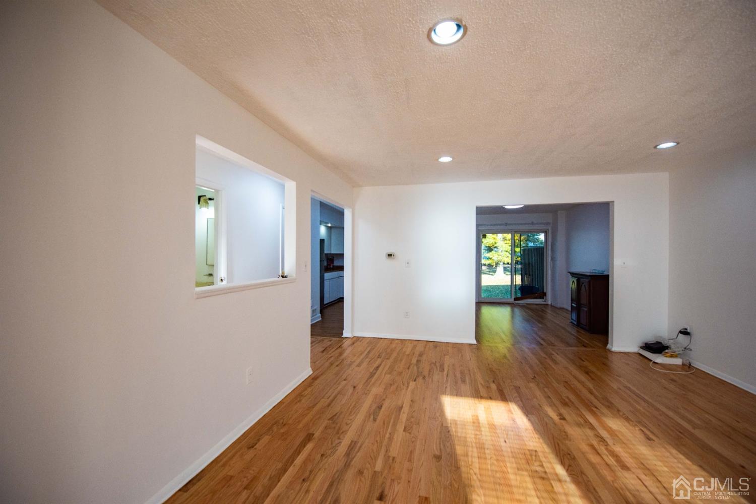 4507 Hana Road Edison, NJ 08817 - Photo 6 of 15 a view of a hallway with wooden floor and a living room