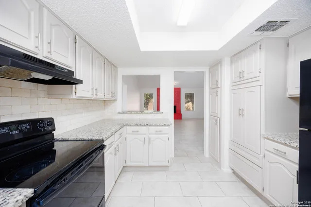 a kitchen with cabinets and stainless steel appliances