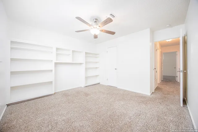 a bathroom with a granite countertop sink a toilet and shower