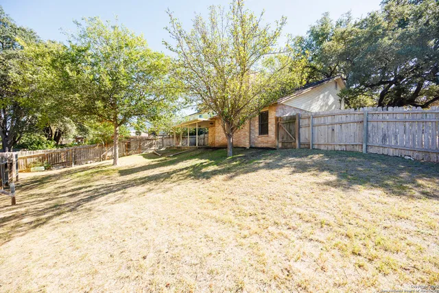 a backyard of a house with yard and outdoor seating