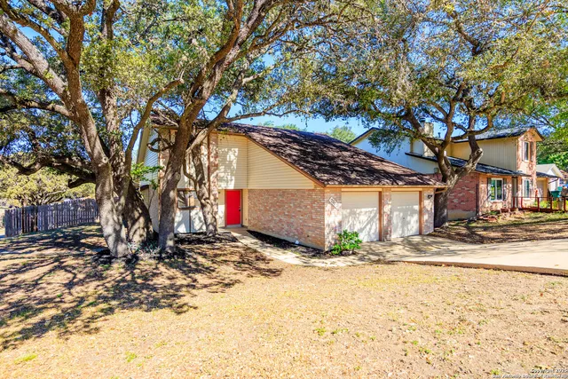 a view of a house with snow on the tree