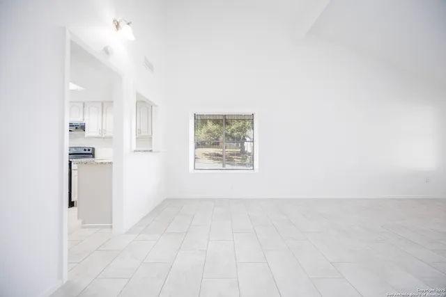 a view of a kitchen with a sink and a window