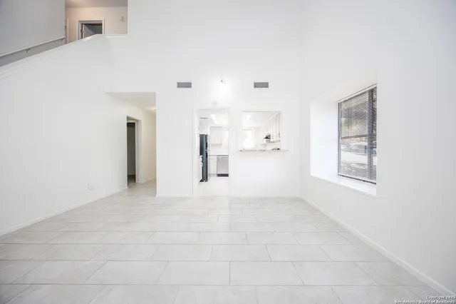a view of a dining room with furniture and window