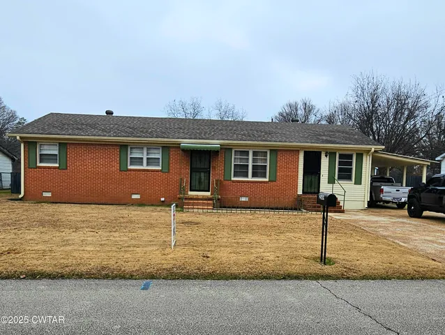 a house that has a tree in front of it