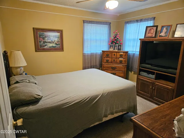 a bedroom with a bed and a television