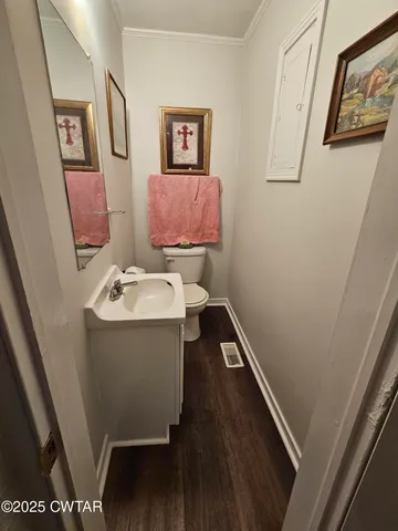 a bathroom with a sink and mirror with toilet