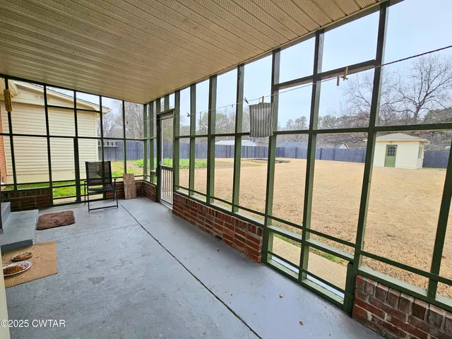 a view of an empty room with a large window