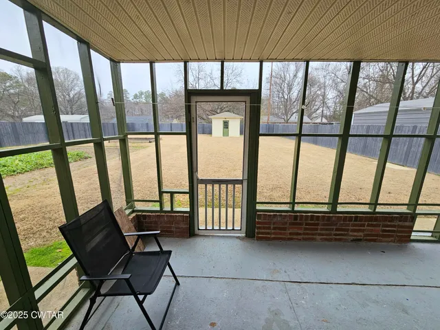 a view of a room with furniture and a window