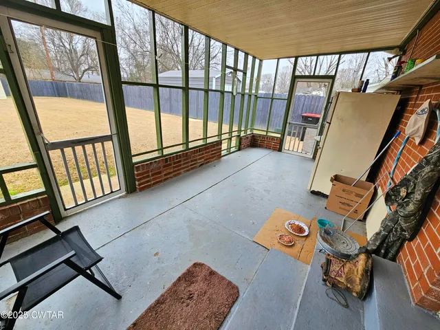 a view of a hallway with furniture and a gate
