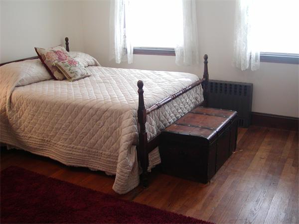 12 Shore Garden Road Hull, MA 02045 - Photo 5 of 22 a bedroom with a bed and wooden floor