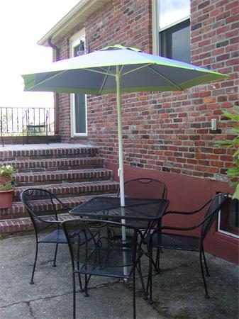 12 Shore Garden Road Hull, MA 02045 - Photo 9 of 22 a backyard of a house with table and chairs