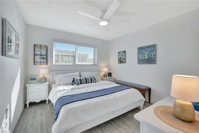 a bedroom with two beds and a lamp