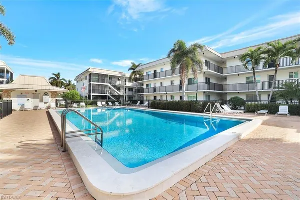 a view of a swimming pool with a lounge chair