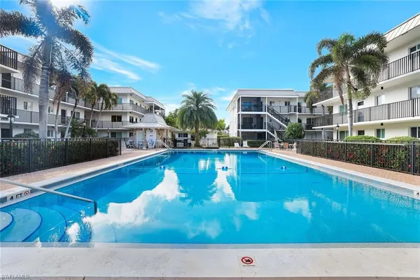 a view of swimming pool with outdoor seating