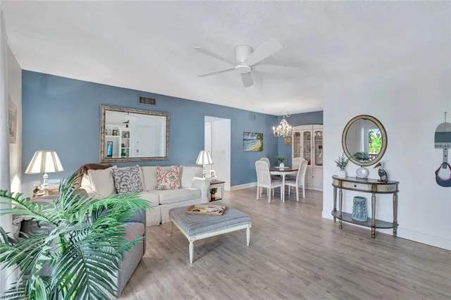 a living room with furniture a rug and a window