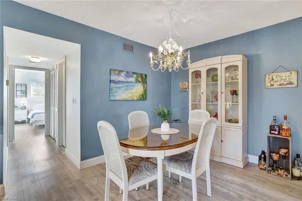 a view of a dining room with furniture wooden floor and chandelier