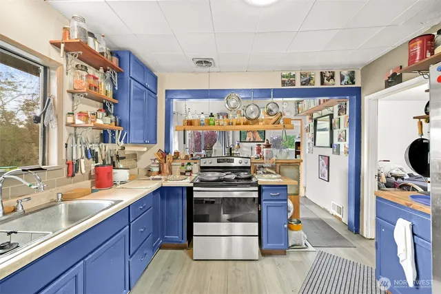 a living room with furniture a flat screen tv and a floor to ceiling window