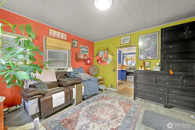 a living room with furniture a flat screen tv and floor to ceiling window