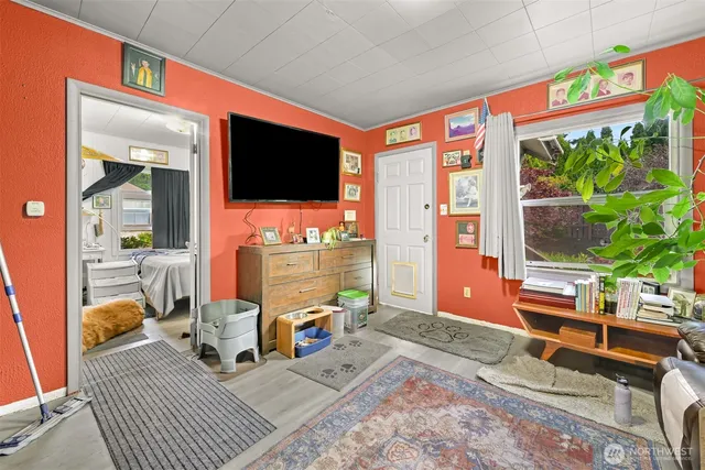 a living room with furniture and a floor to ceiling window