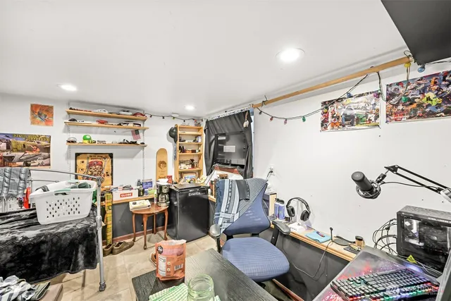 a bed sitting in a bedroom next to a window