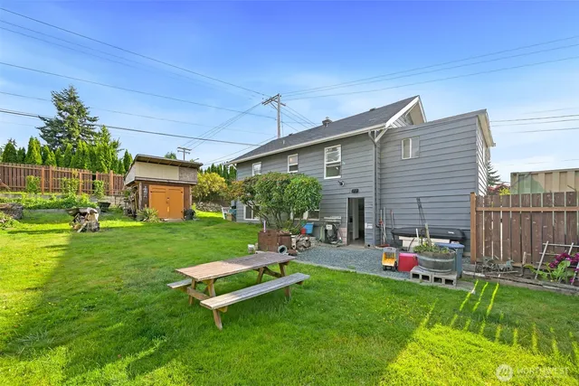 a view of a house with a yard and sitting area
