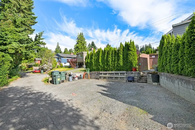 a front view of a house with a garden and plants