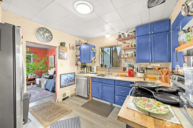 a kitchen with stainless steel appliances granite countertop a stove and a sink