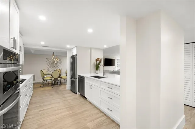 a kitchen with kitchen island cabinets and chairs in it