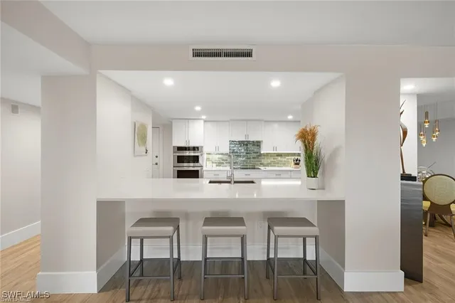 a living room with furniture wooden floor and a flat screen tv