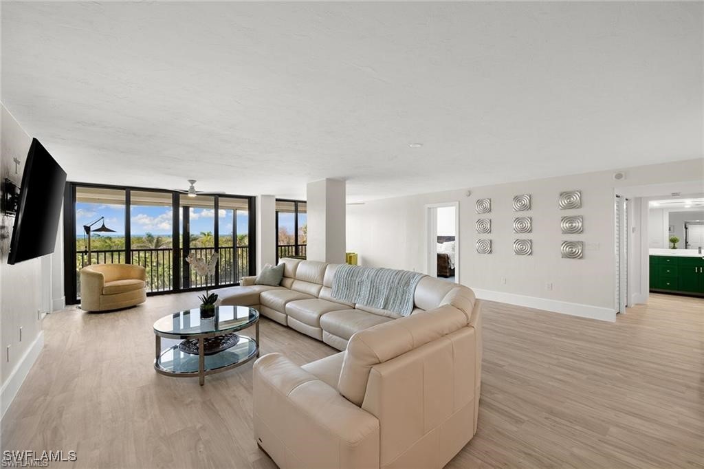 5601 Turtle Bay Drive, Unit 302 Naples, FL 34108 - Photo 16 of 44 a living room with furniture and a large window