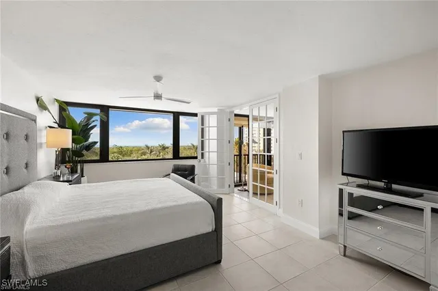 a spacious bedroom with a bed and a large window