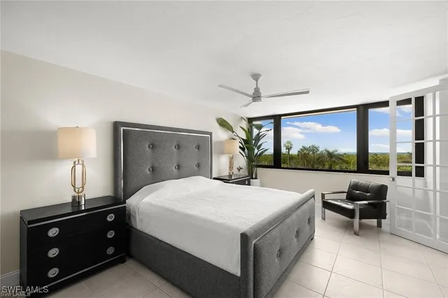 a bedroom with a bed and a potted plant