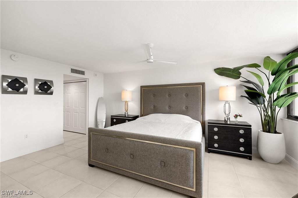 5601 Turtle Bay Drive, Unit 302 Naples, FL 34108 - Photo 19 of 44 a bedroom with a bed and a potted plant