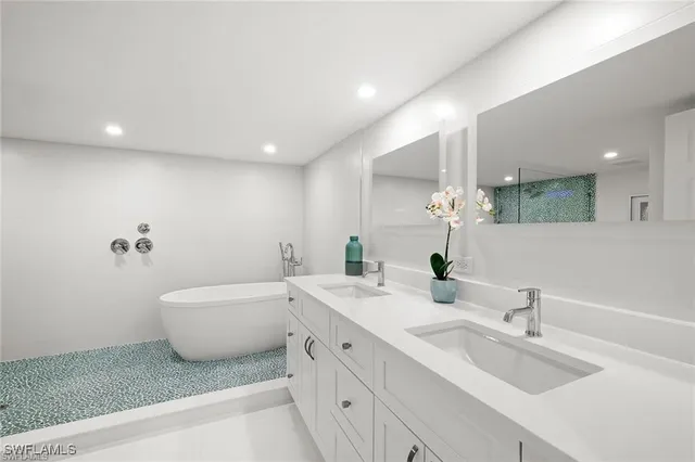 a spacious bathroom with a double vanity sink and a mirror