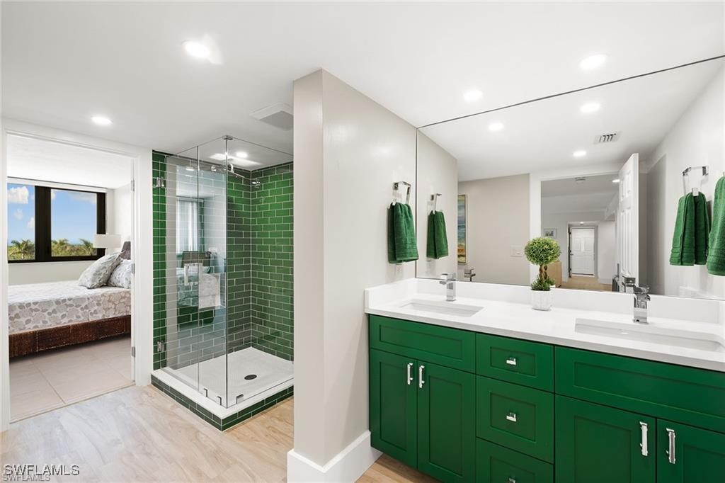 5601 Turtle Bay Drive, Unit 302 Naples, FL 34108 - Photo 25 of 44 a bathroom with a double vanity sink and shower