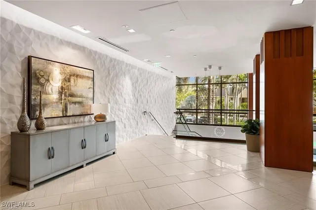 a living room with furniture a rug and a large window
