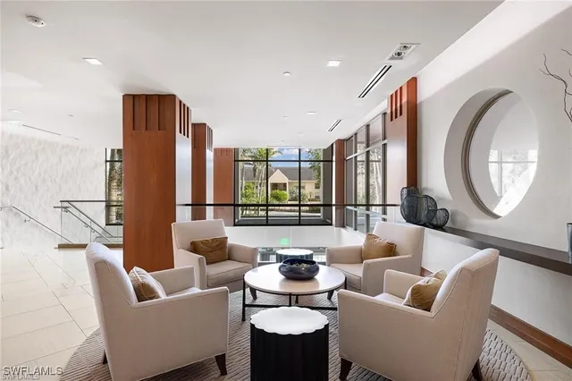 a living room with fireplace furniture and a large window
