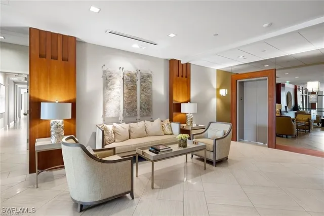 a kitchen with stainless steel appliances granite countertop table chairs sink and cabinets