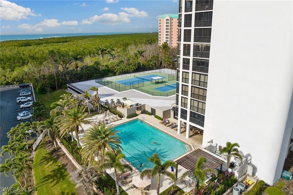 5601 Turtle Bay Drive, Unit 302 Naples, FL 34108 - Photo 3 of 44 a view of a balcony with floor to ceiling windows with wooden floor
