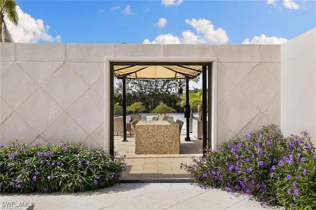 a view of a patio with a table and chairs under an umbrella