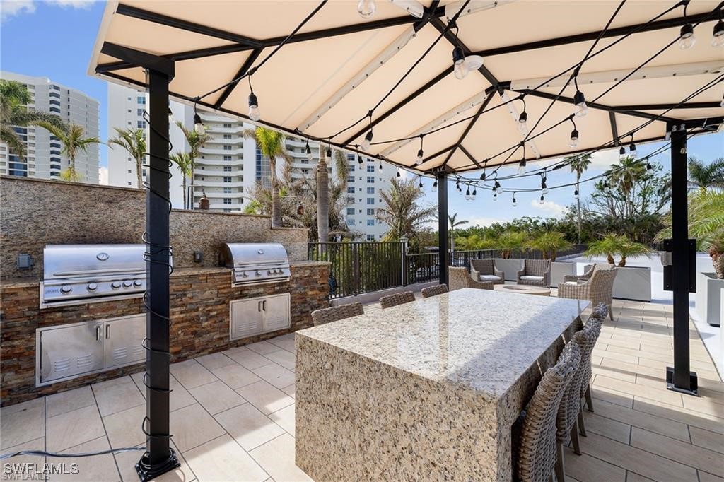 5601 Turtle Bay Drive, Unit 302 Naples, FL 34108 - Photo 35 of 44 a patio view with a table and chairs