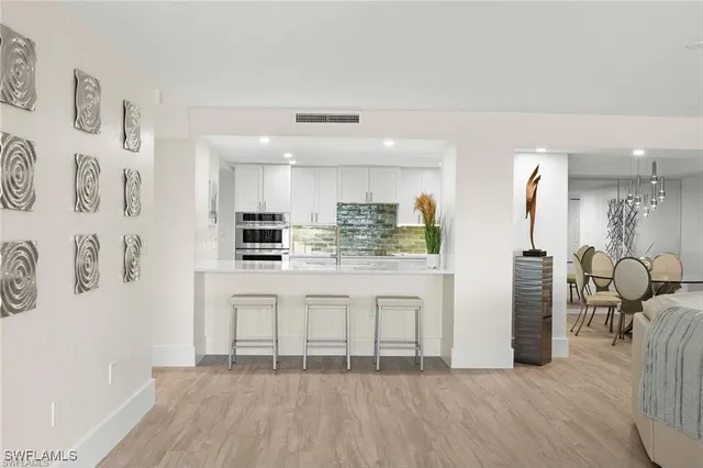 a kitchen with a refrigerator and a more cabinets