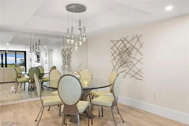 a view of a dining room with furniture and chandelier