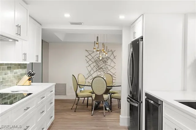a kitchen with stainless steel appliances kitchen island sink stove and cabinets