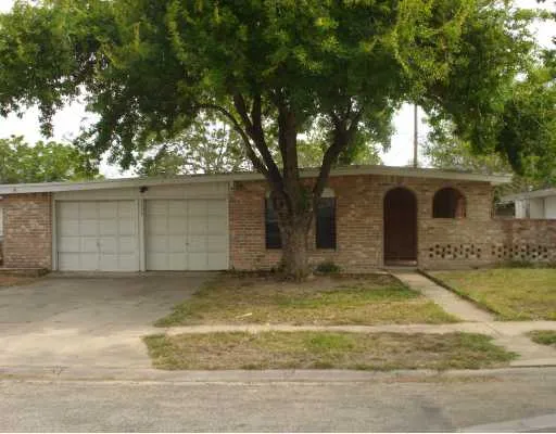 a view of a house with a large tree