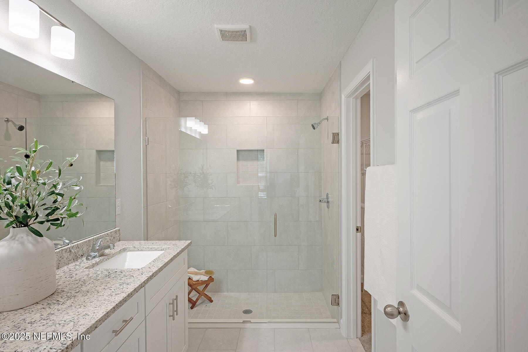 8768 Orme Road Jacksonville, FL 32220 - Photo 28 of 36 a bathroom with a granite countertop sink a mirror a bathtub and shower