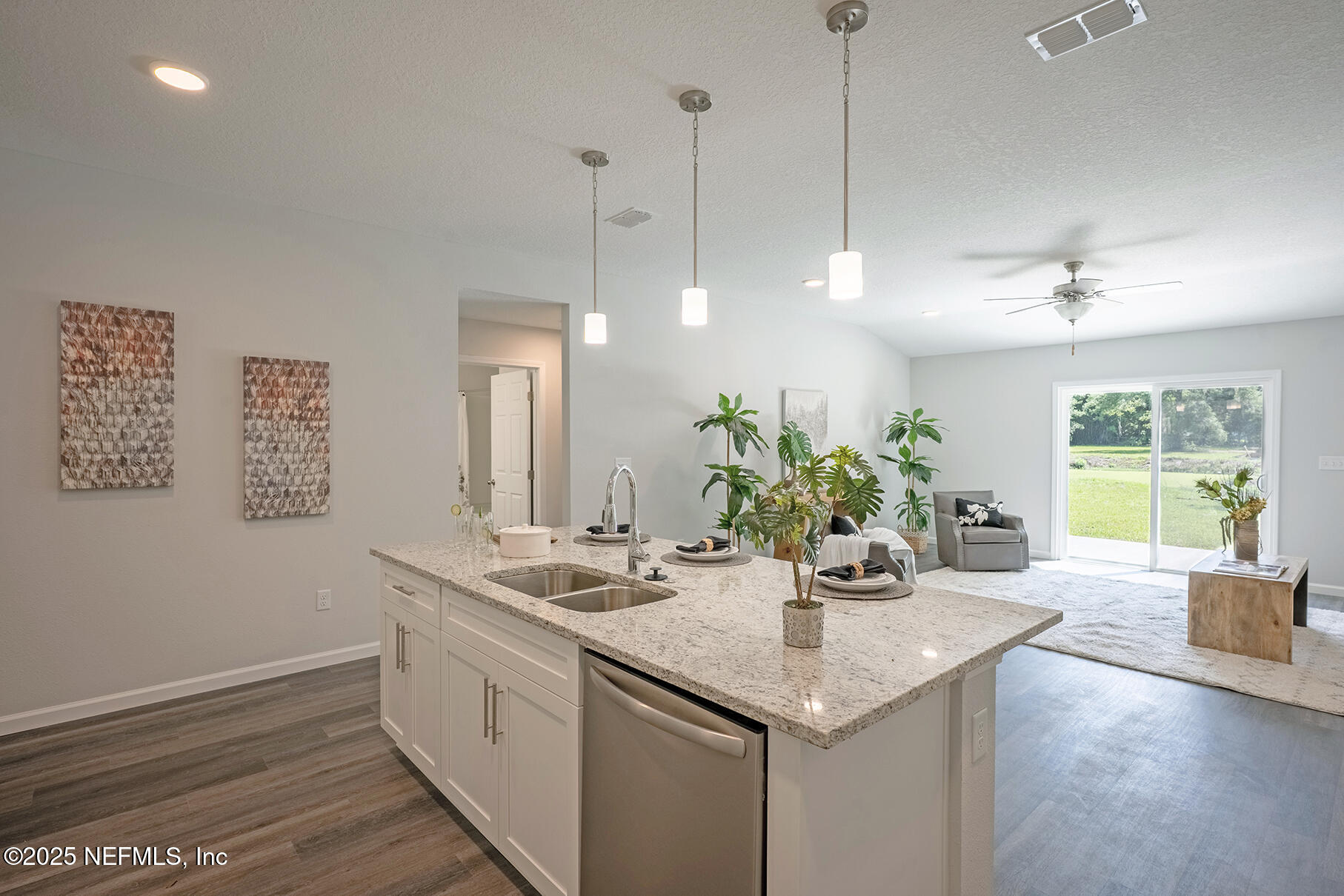 8768 Orme Road Jacksonville, FL 32220 - Photo 36 of 36 a kitchen with a sink dishwasher and a wooden floor