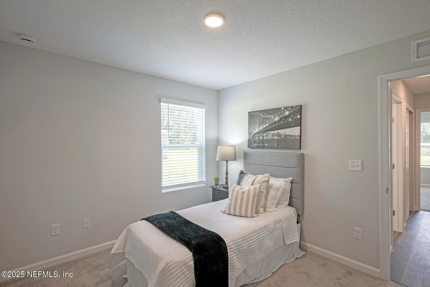 8768 Orme Road Jacksonville, FL 32220 - Photo 5 of 36 a bedroom with a bed and a window