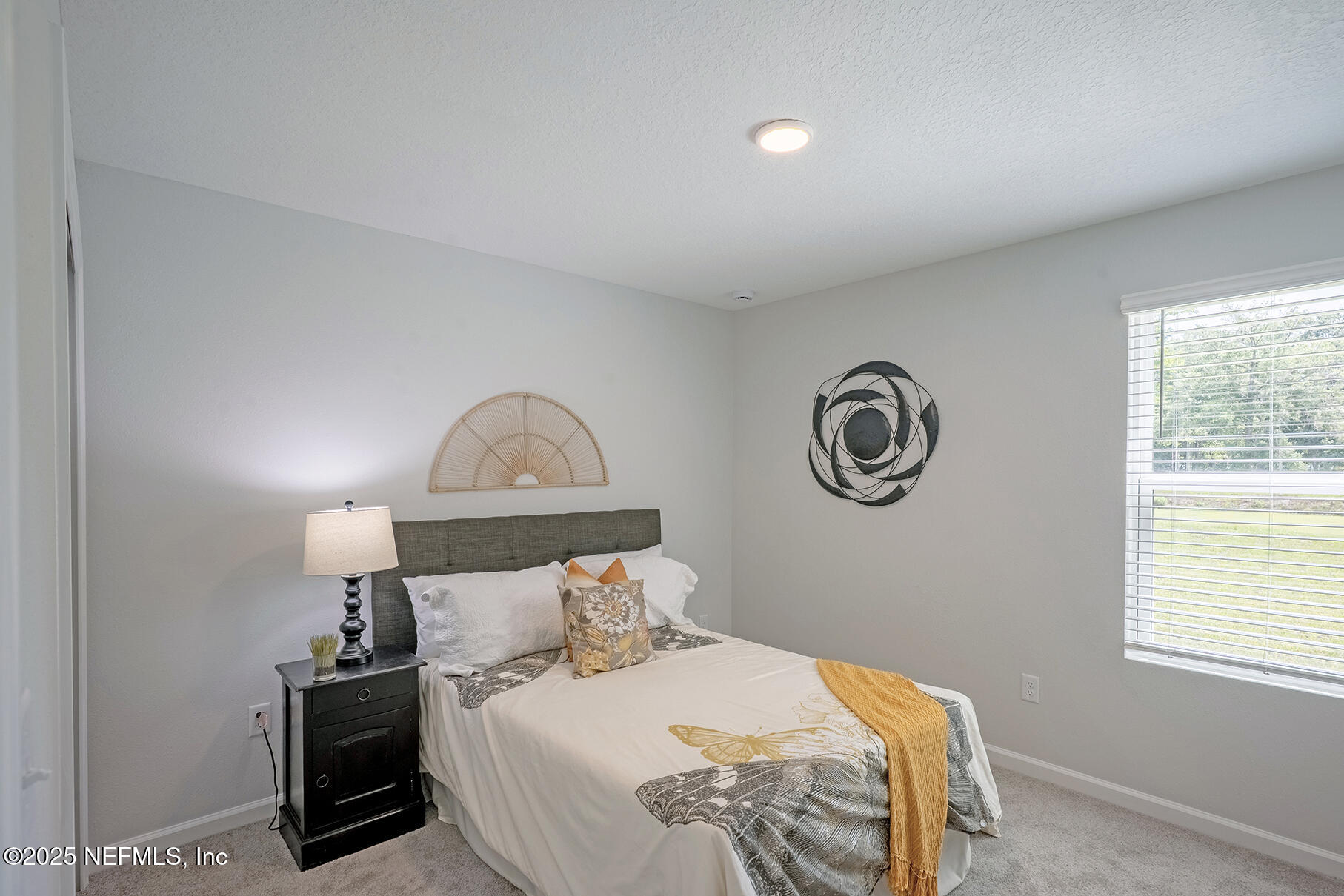 8768 Orme Road Jacksonville, FL 32220 - Photo 9 of 36 a bedroom with a bed and a window