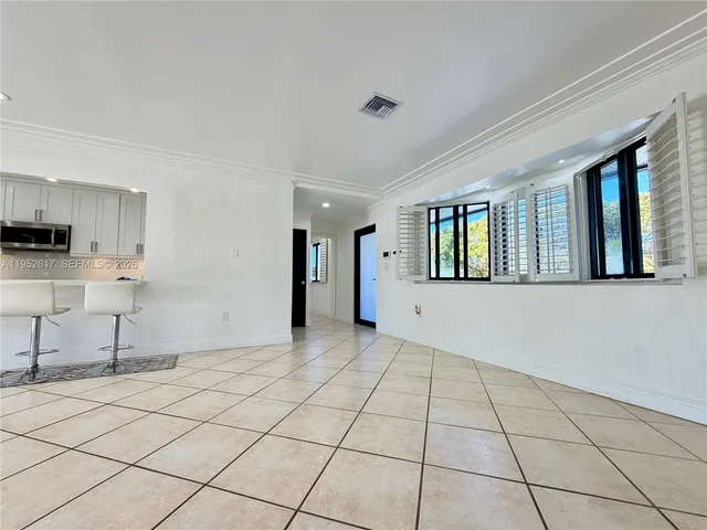 a kitchen with refrigerator a microwave and cabinets